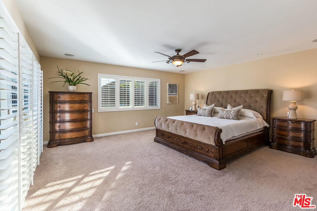 4304 Olympiad Drive View Park, CA 90043 - Photo 33 of 44 a bedroom with a bed a dresser and a chandelier