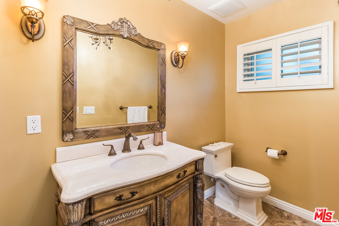 4304 Olympiad Drive View Park, CA 90043 - Photo 36 of 44 a bathroom with a sink a toilet and a mirror