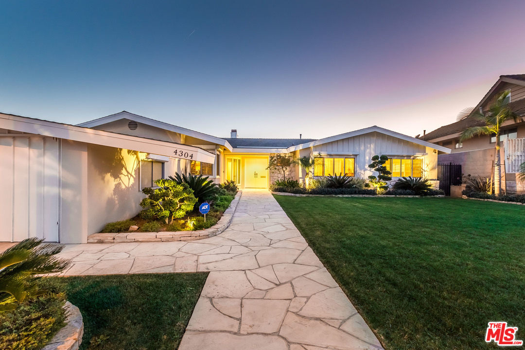 4304 Olympiad Drive View Park, CA 90043 - Photo 43 of 44 a front view of a house with garden