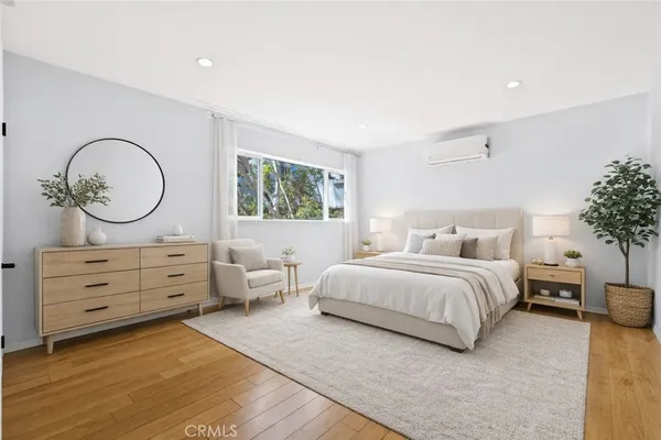 a bedroom with a bed and a potted plant