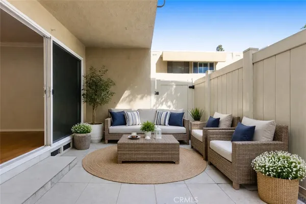 a living room with furniture and a potted plant