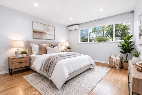 a bedroom with bed and a large window