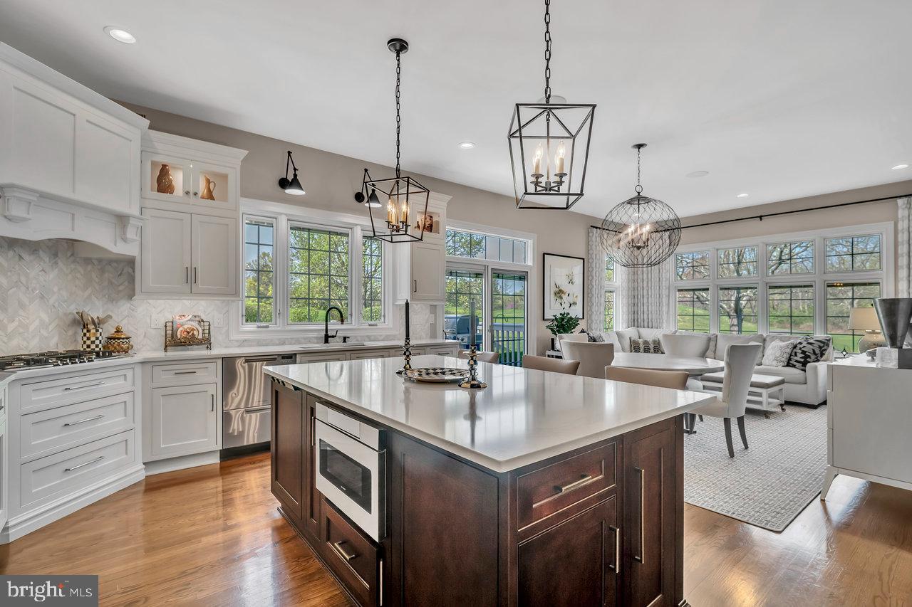 17 Banyan Road Skillman, NJ 08558 - Photo 16 of 53 a open kitchen with stainless steel appliances granite countertop a sink a stove and a wooden floors