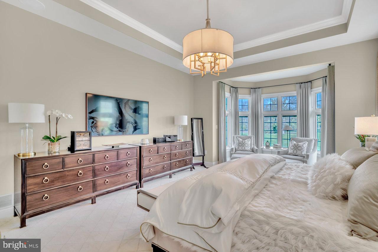 17 Banyan Road Skillman, NJ 08558 - Photo 25 of 53 a bedroom with a large bed and a chandelier