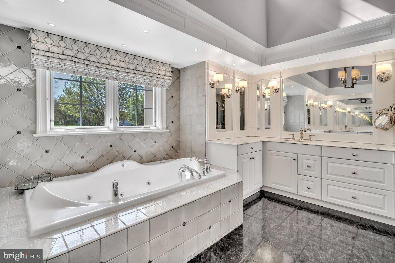 17 Banyan Road Skillman, NJ 08558 - Photo 28 of 53 a bathroom with a tub sink and mirror