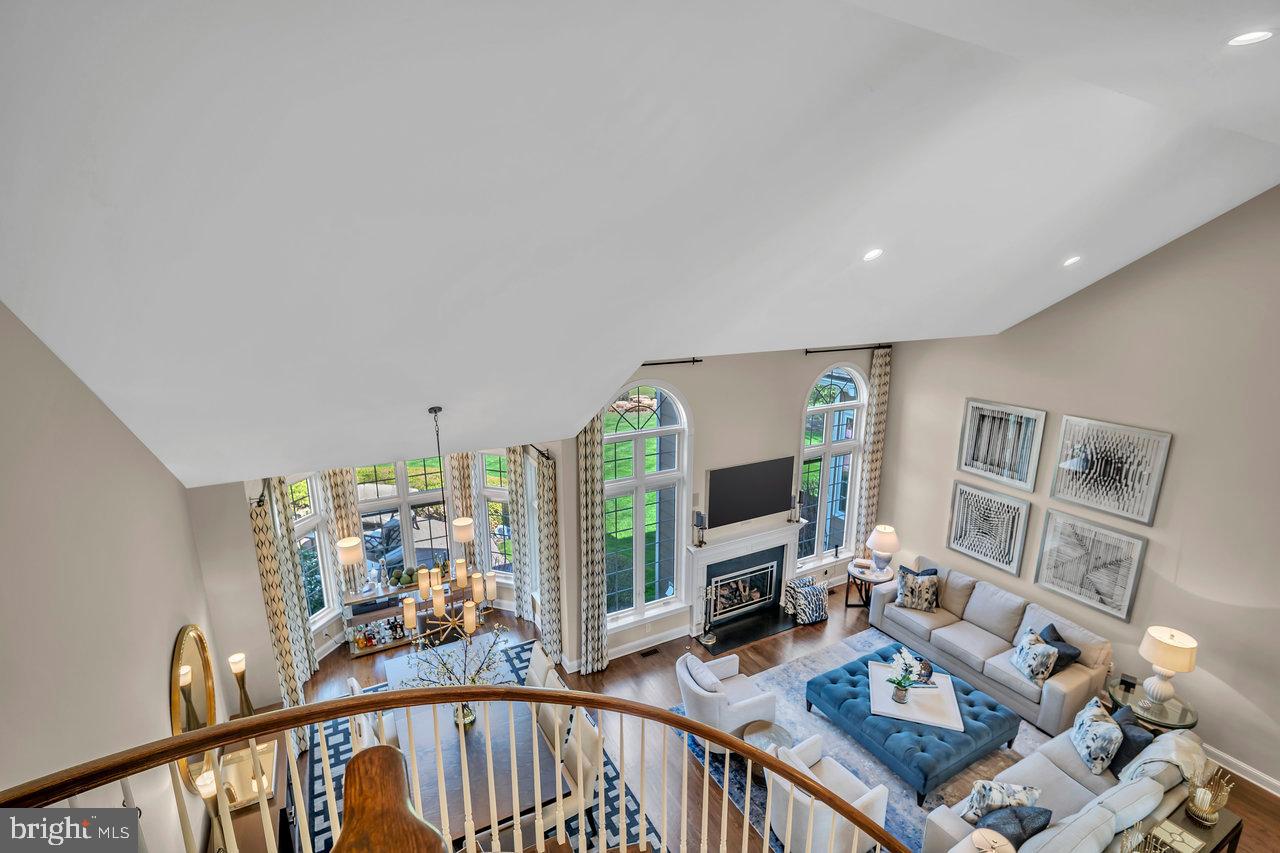 17 Banyan Road Skillman, NJ 08558 - Photo 31 of 53 a living room with furniture a flat screen tv and a floor to ceiling window