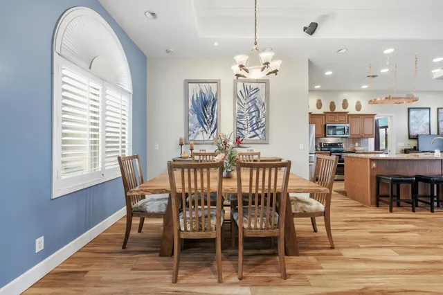 a view of a dining room with furniture and wooden floor
