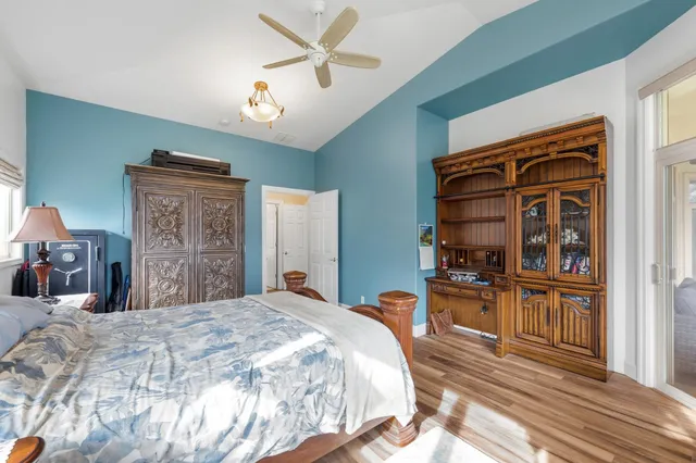 a bedroom with a bed dresser and a large mirror