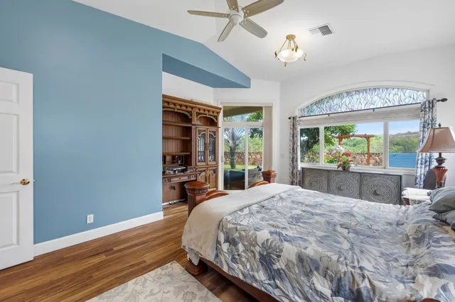 a large bedroom with a bed and a large window with the outer view