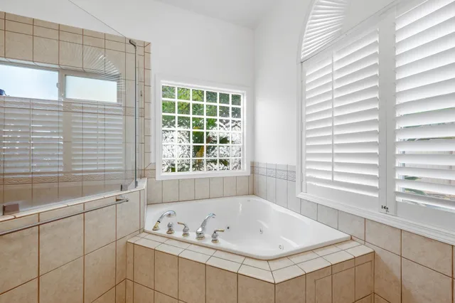 a bath tub sitting next to a window