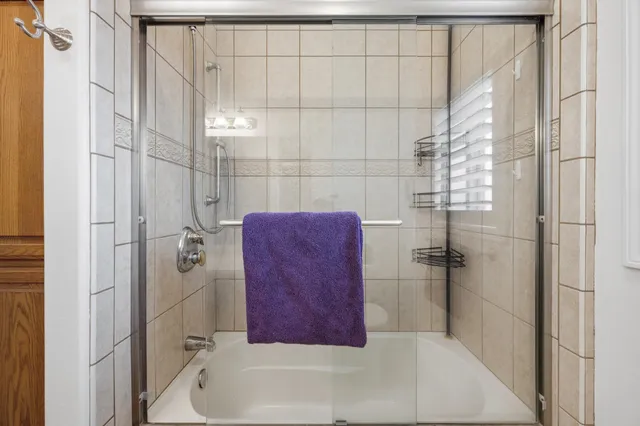 a bathroom with a bathtub and a shower