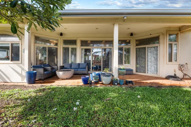 a view of a house with backyard porch and sitting area