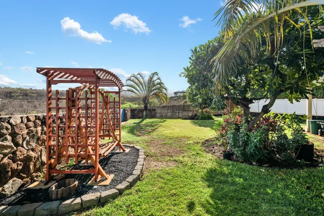 a view of swimming pool with a garden and plants
