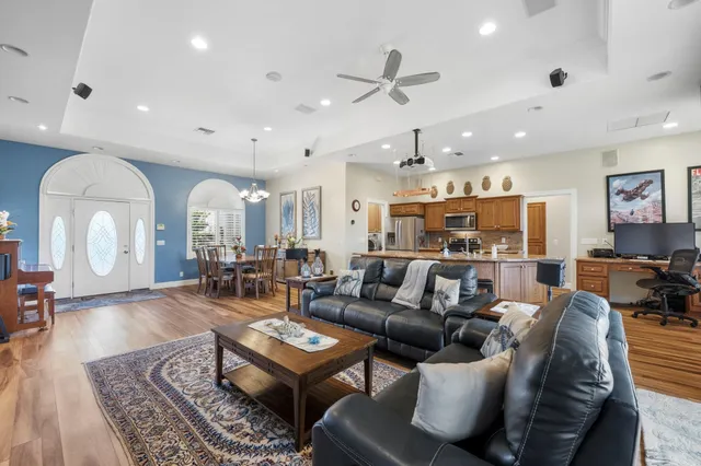 a living room with lots of furniture and view of kitchen