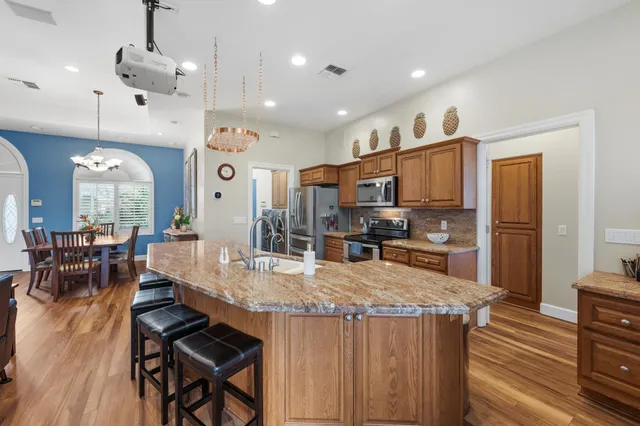 a large kitchen with a table and chairs