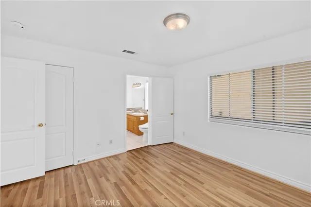 a view of a room with wooden floor and white walls