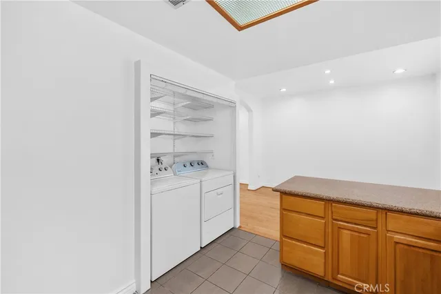 a kitchen with a sink window and cabinets