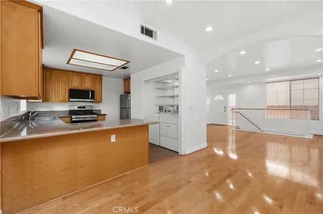 a kitchen with stainless steel appliances granite countertop a stove and a sink