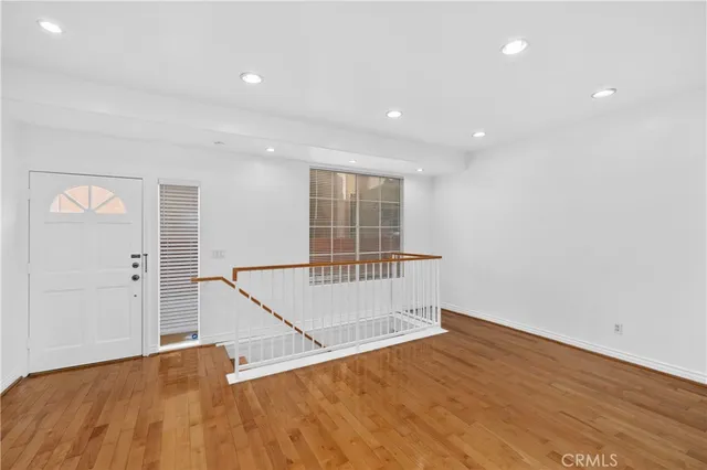 a view of an entryway with wooden floor