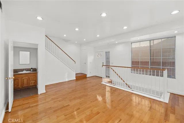 a view of entryway and hall with wooden floor