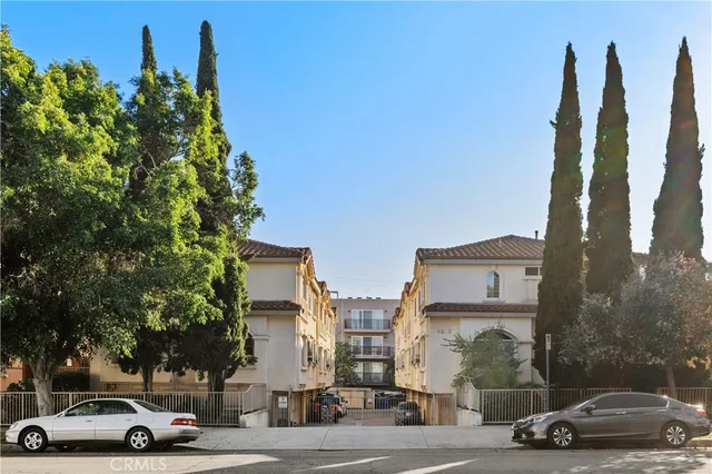a view of a white building with large windows