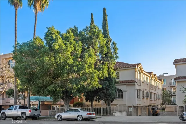 a front view of a house with a tree