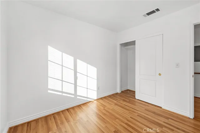 a view of a room with wooden floor