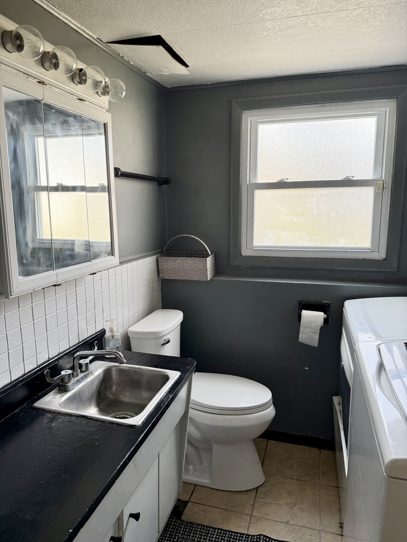 5653 Dover Road Oak Forest, IL 60452 - Photo 8 of 17 a bathroom with a sink a toilet and a window
