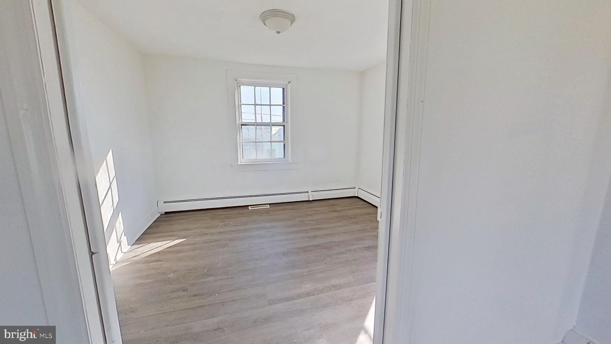 127 Nashville Boulevard Spring Grove, PA 17362 - Photo 13 of 16 an empty room with wooden floor and windows