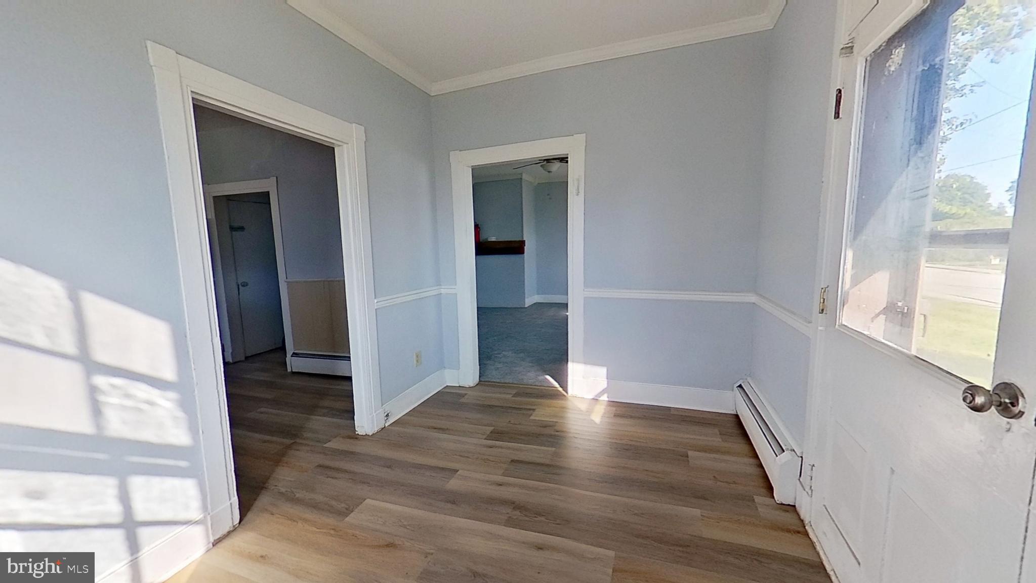 127 Nashville Boulevard Spring Grove, PA 17362 - Photo 2 of 16 an empty room with wooden floor and windows