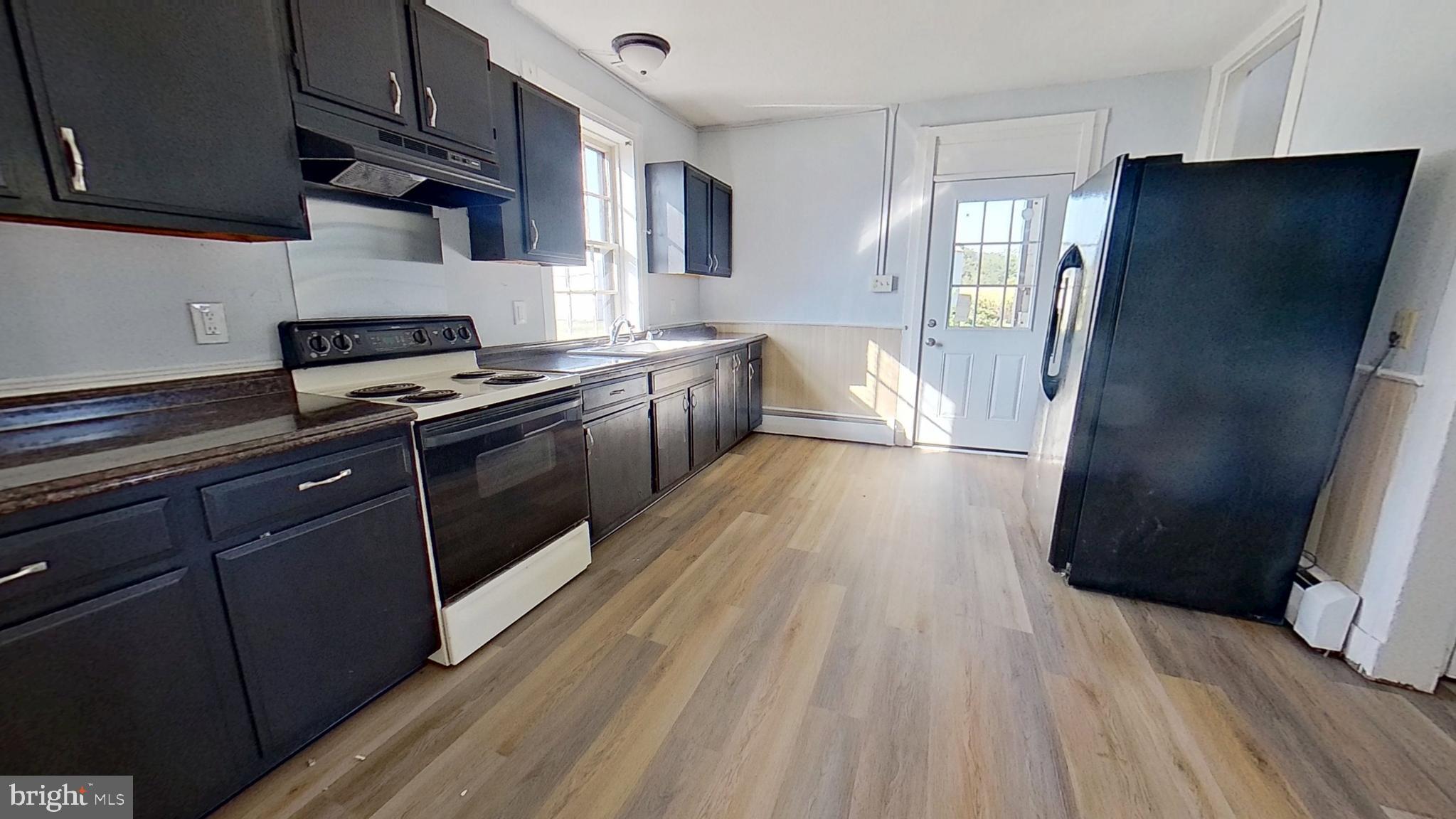 127 Nashville Boulevard Spring Grove, PA 17362 - Photo 3 of 16 a kitchen with stainless steel appliances a refrigerator and wooden floor