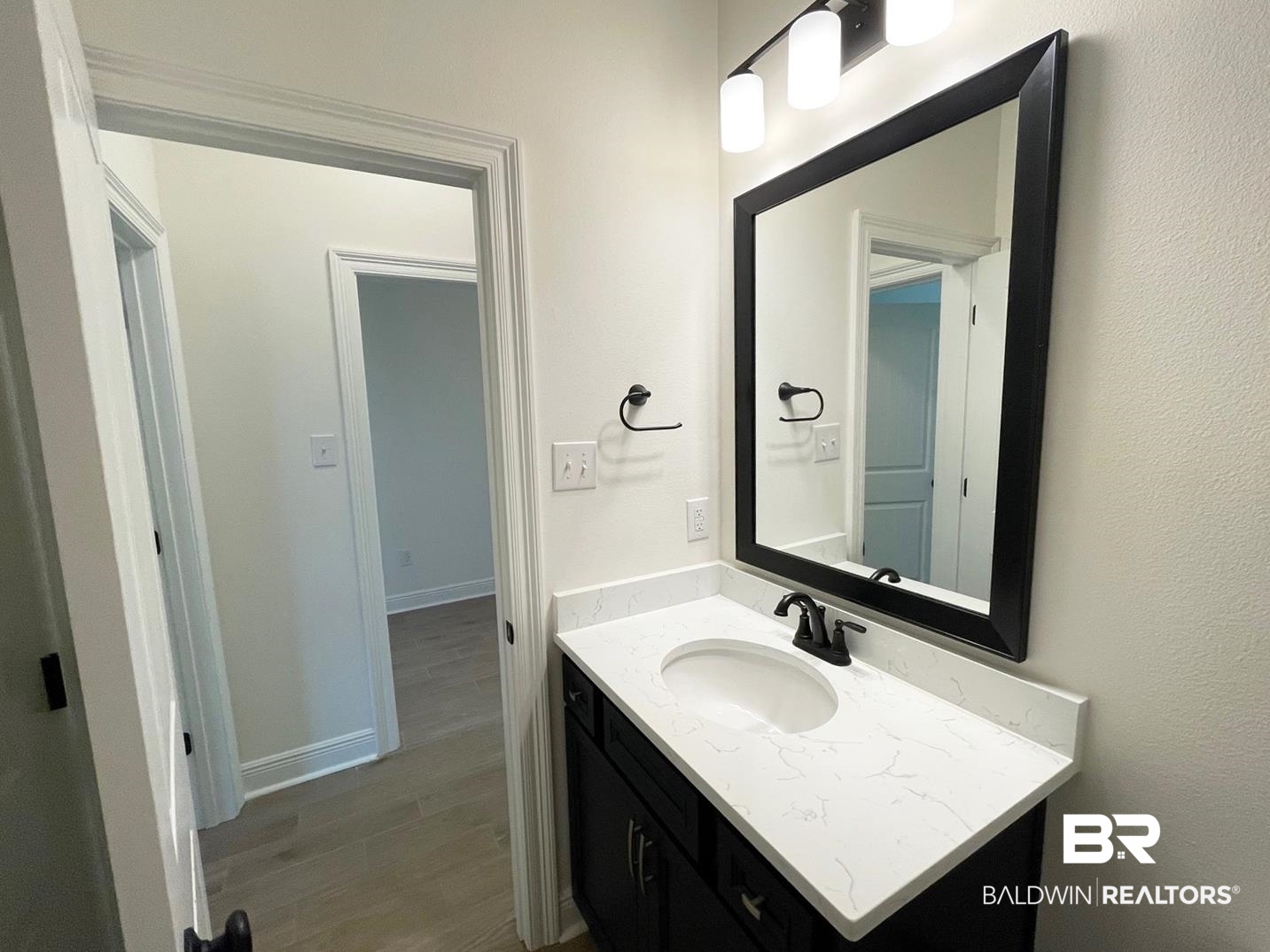 1565 Fenton Circle Foley, AL 36535 - Photo 10 of 15 Bathroom with wood-type flooring and vanity