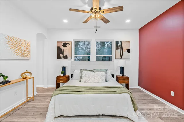 a bedroom with a bed and wooden floor