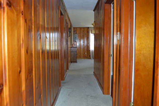 a view of a small space with wooden floor and a window