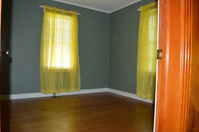 a large bed sitting in a bedroom next to a window
