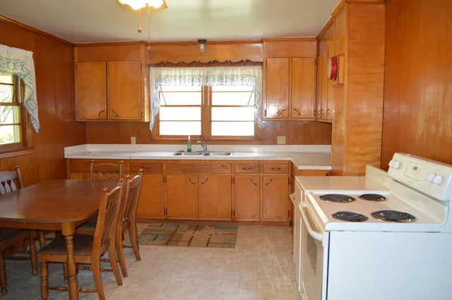 a kitchen with a stove a sink and a refrigerator