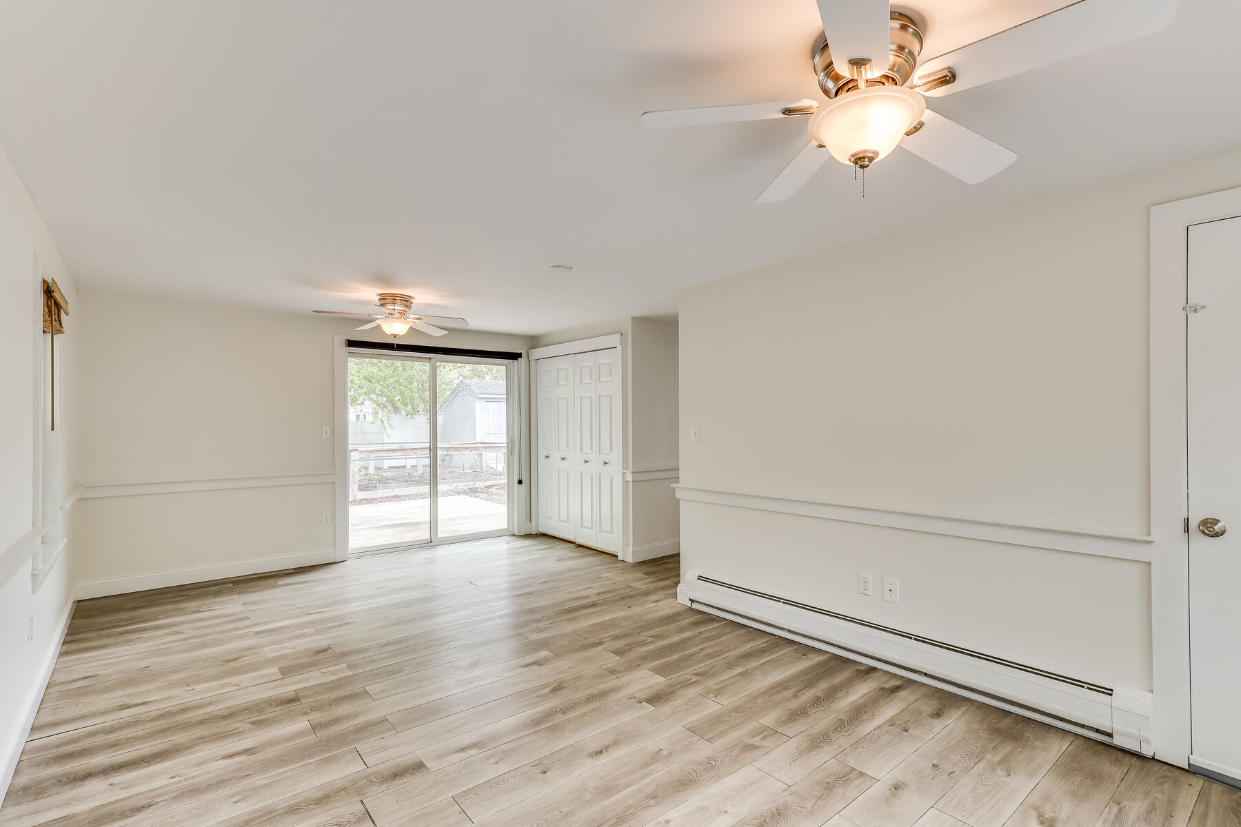 8 Shannon Road Harwich, MA 02645 - Photo 32 of 41 an empty room with wooden floor fan and windows
