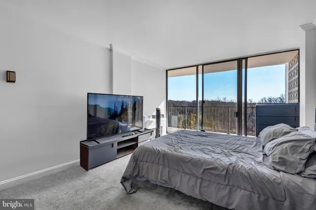 a bedroom with a bed and large window