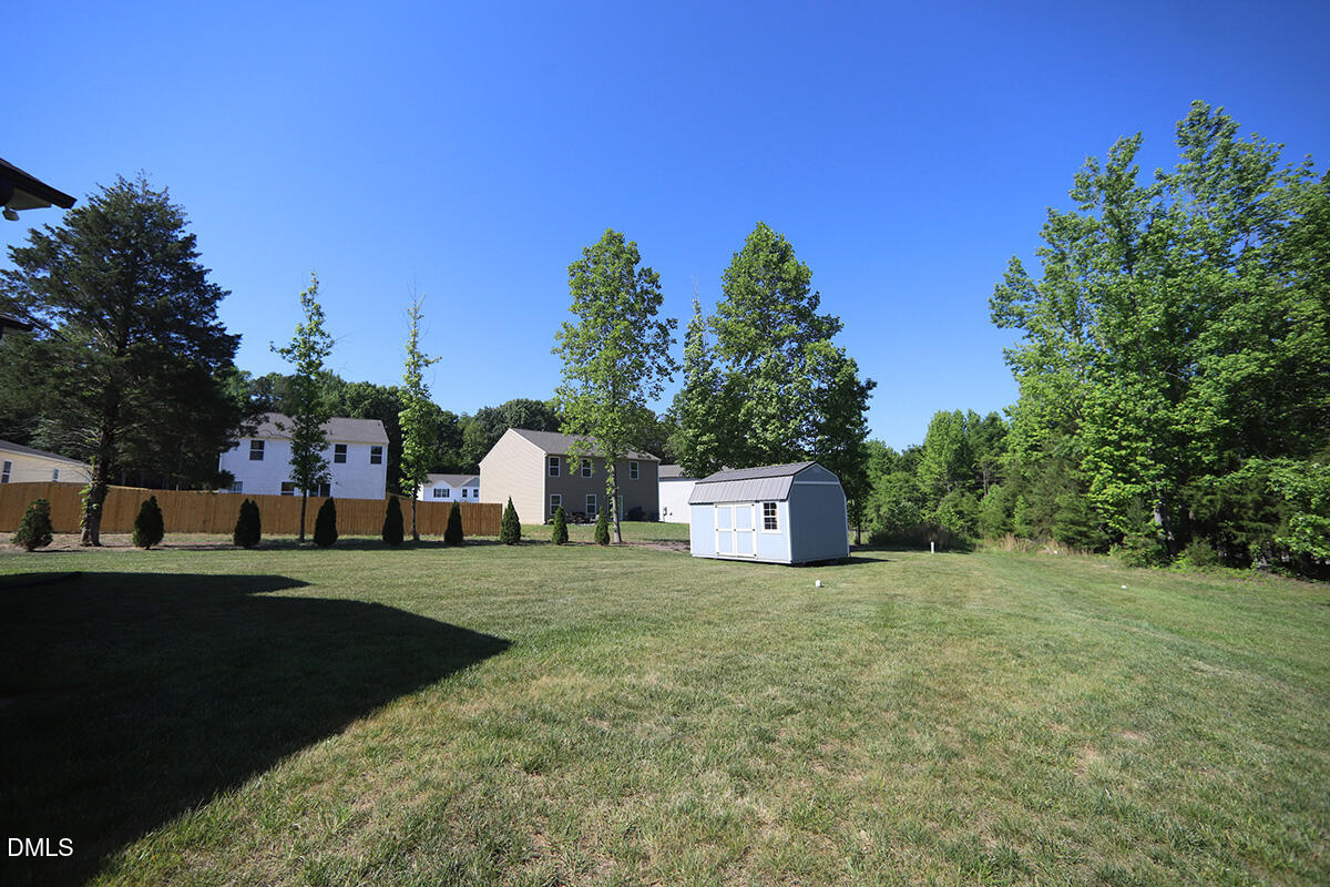 125 Mae Court Roxboro, NC 27573 - Photo 27 of 30 a view of a white house with a yard and sitting area