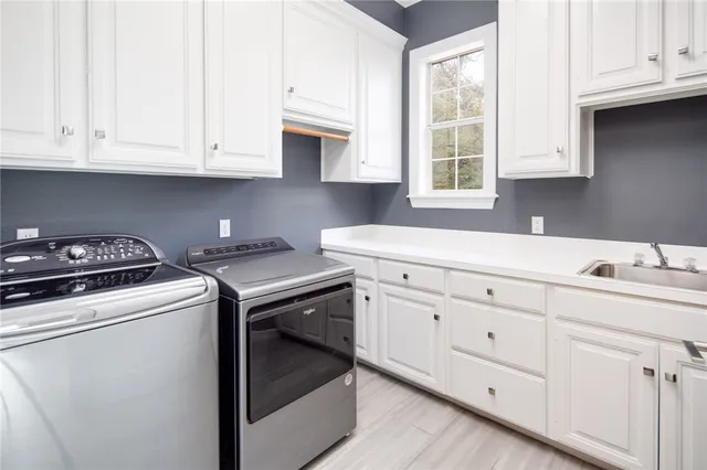 a kitchen with white cabinets and white appliances