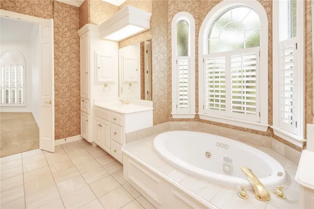 a bathroom with a tub sink and mirror