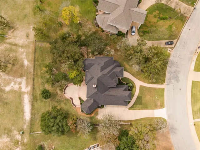 an aerial view of a house with a yard