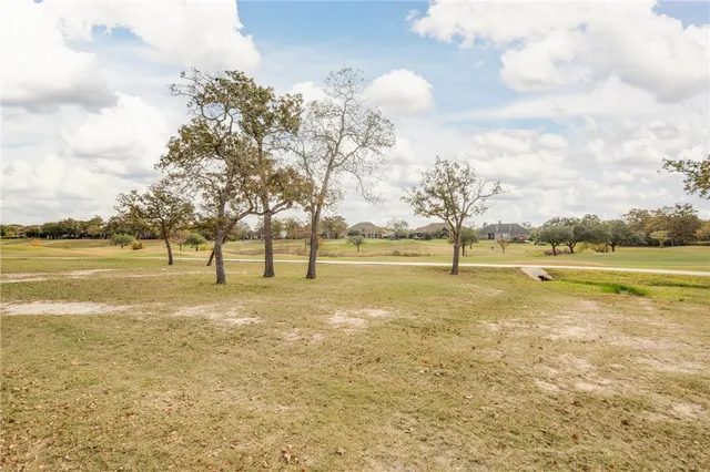 a view of yard with swimming pool and trees