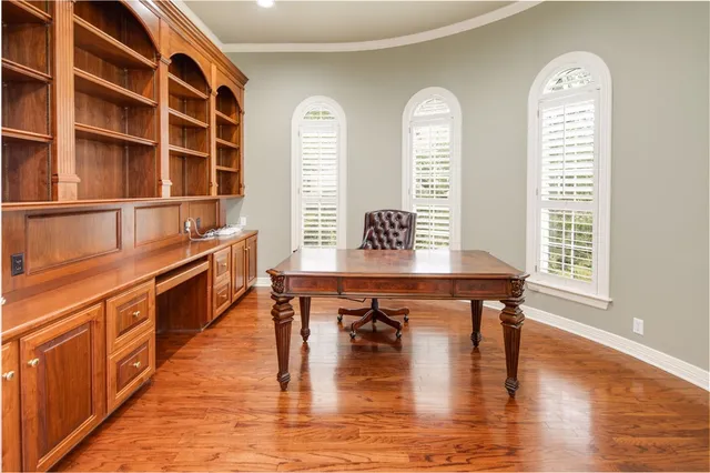 a view of a room with wooden floor and windows