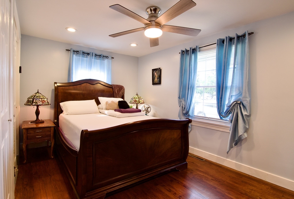 75 Wilton Street Springfield, MA 01109 - Photo 23 of 42 a bedroom with a bed and a large window with wooden floor