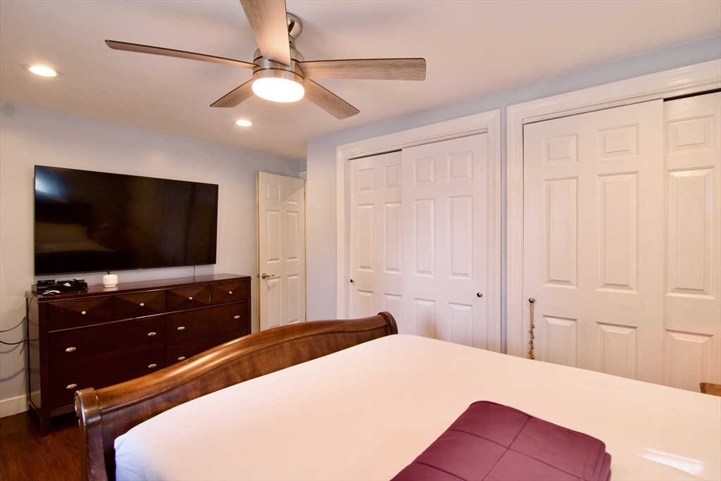 75 Wilton Street Springfield, MA 01109 - Photo 26 of 42 a bedroom with a bed and a flat screen tv