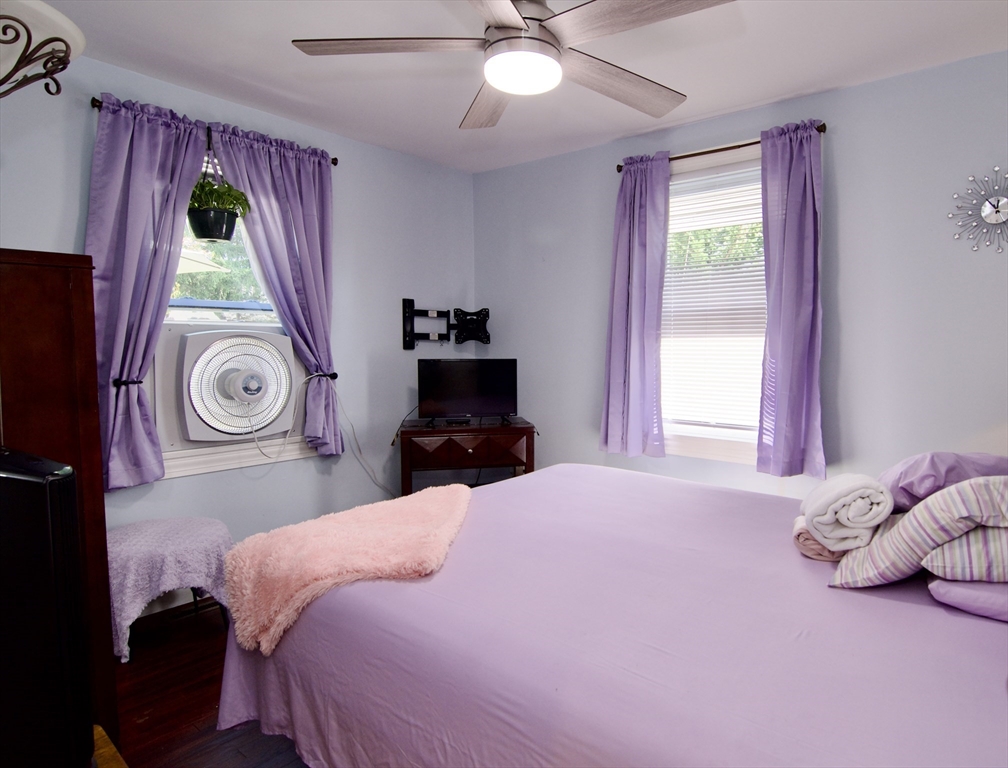 75 Wilton Street Springfield, MA 01109 - Photo 27 of 42 a bedroom with a bed and a chandelier