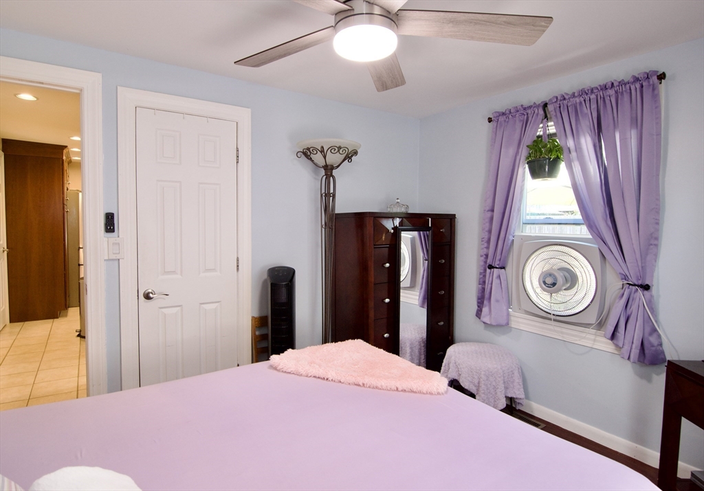 75 Wilton Street Springfield, MA 01109 - Photo 29 of 42 a bedroom with a bed and a chandelier