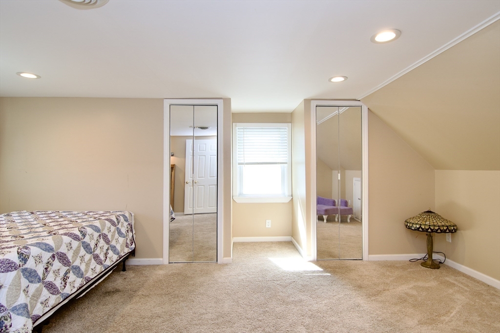 75 Wilton Street Springfield, MA 01109 - Photo 31 of 42 a bedroom with a bed and a table in it
