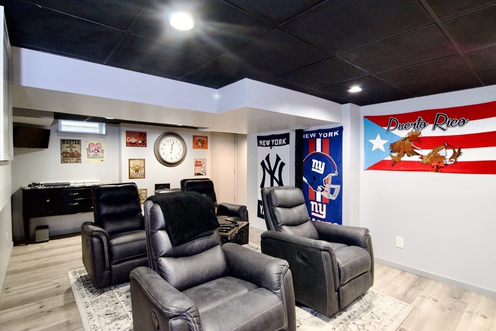 75 Wilton Street Springfield, MA 01109 - Photo 39 of 42 a living room with furniture a ceiling fan and a rug
